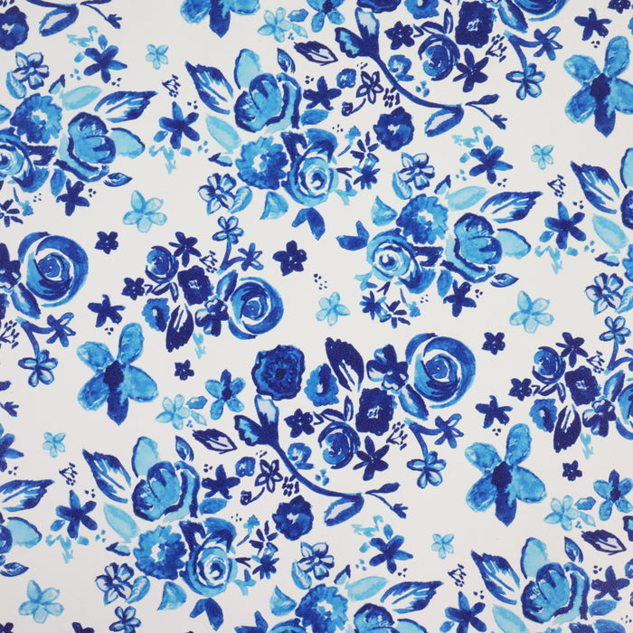 This floral print is in shades of blue with a white background.