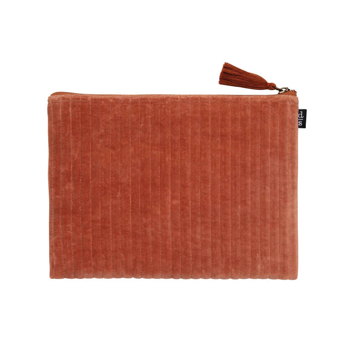 Dark orange velvet quilted flat pouch with a tassel on a white background.