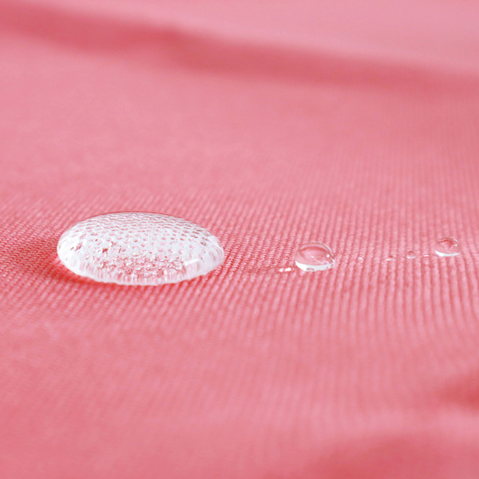 This WPC-Lite is in a pale, yet saturated, red. This photo shows water drops on the fabric.