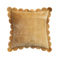 Mustard yellow velvet pillow with scalloped edge on a white background.