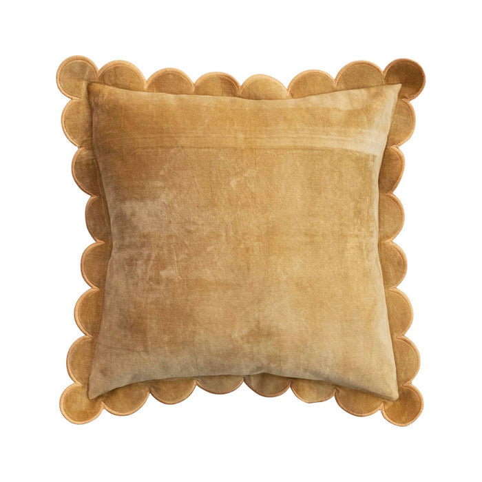 Mustard yellow velvet pillow with scalloped edge on a white background.
