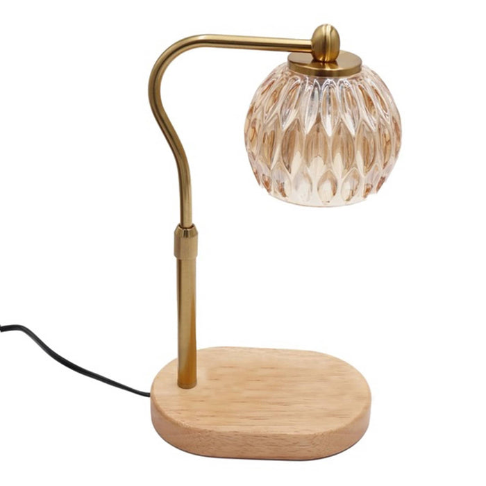 Candle warmer table lamp with crystal amber glass shade, gold stem, and wooden base, side view, on a white background.