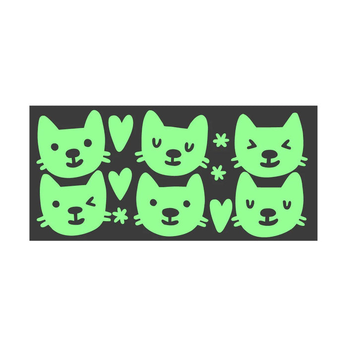 Glow in the dark stickers with cat designs on a black sticker sheet, on a white background.