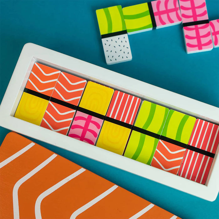 Colorful wood dominoes with various patterns that mimic sushi, on a blue background.