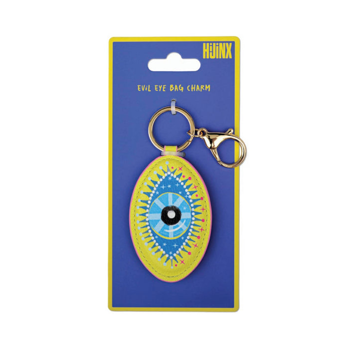 An oval evil eye bag charm keychain on a blue and yellow card backing. The charm features a blue and yellow eye design with a black pupil, surrounded by a yellow border with pink and orange accents.