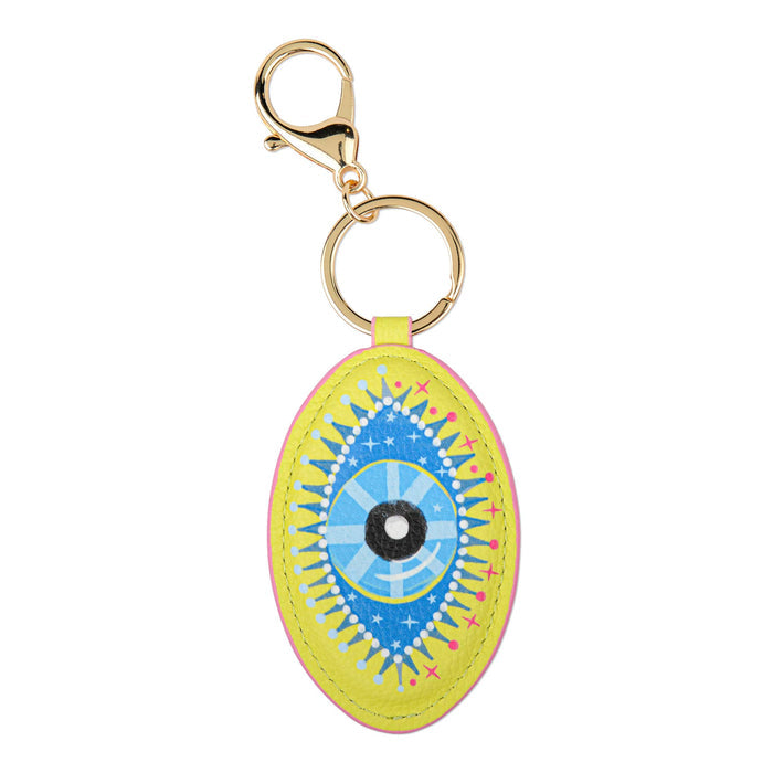 A bright yellow oval keychain featuring a colorful eye illustration with blue, light blue, black, and pink details, attached to gold-tone hardware on a white background.