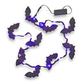 String of bat-shaped lights with purple LED lights on a white background.