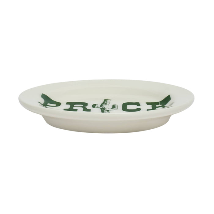 White stoneware plate with green cactus design and text, side view, on a white background.