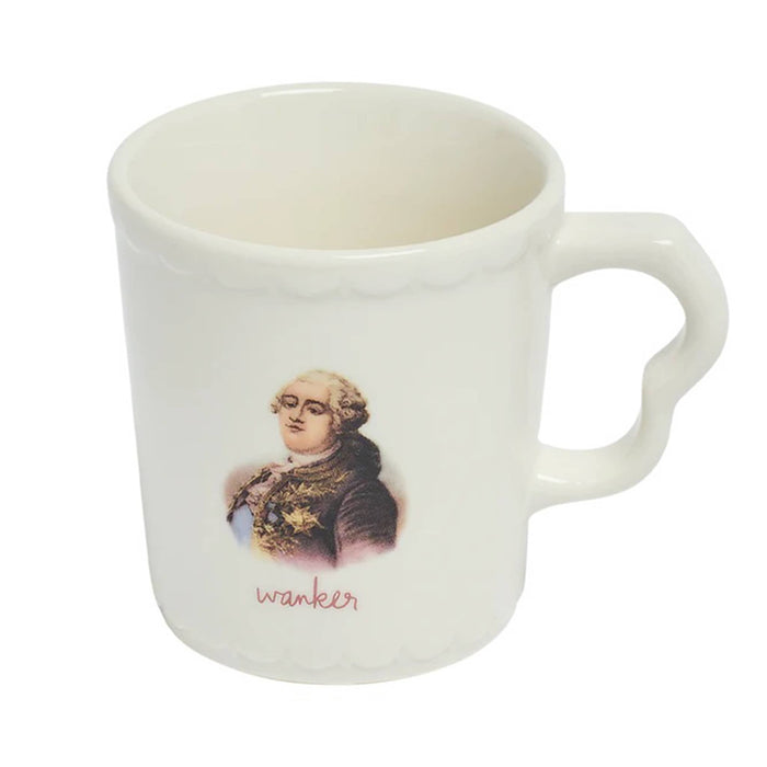 White stoneware mug with an old-timey portrait and the word 'wanker' printed below, slight overhead view, on a white background.