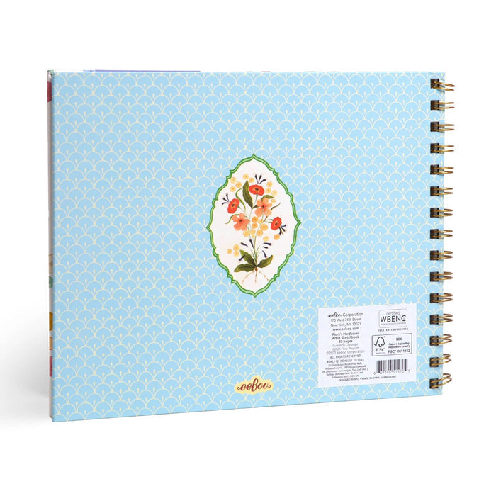 Back of a spiral-bound sketchbook by the brand 'eeboo' with a light blue patterned cover and a central floral illustration, shown on a clean white background.