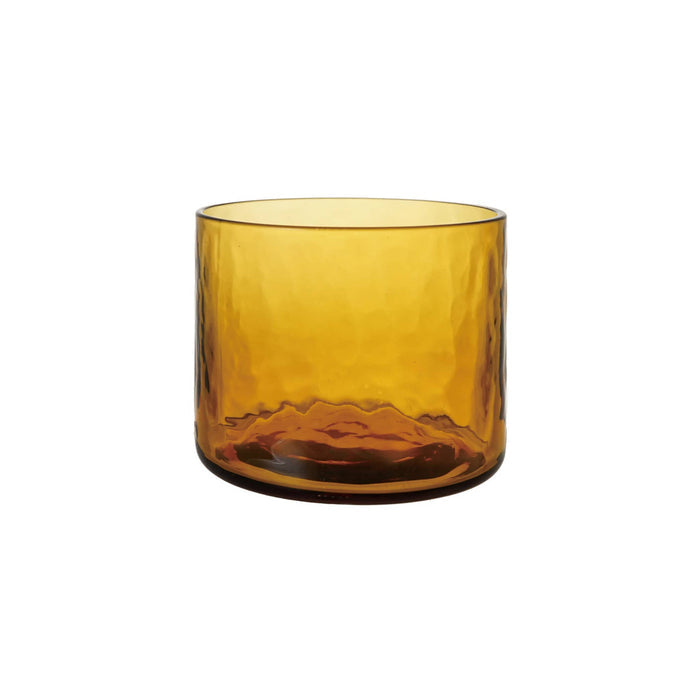 A hammered amber glass tumbler on a white background.