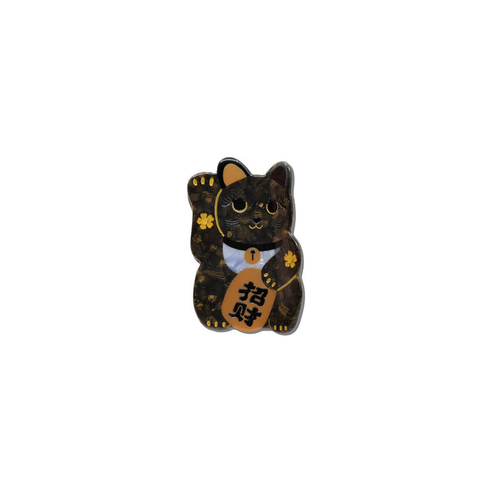 A black cat-shaped charm or pin with gold floral details, a white bow tie, and a gold pouch featuring Chinese characters, shown on a plain white background.