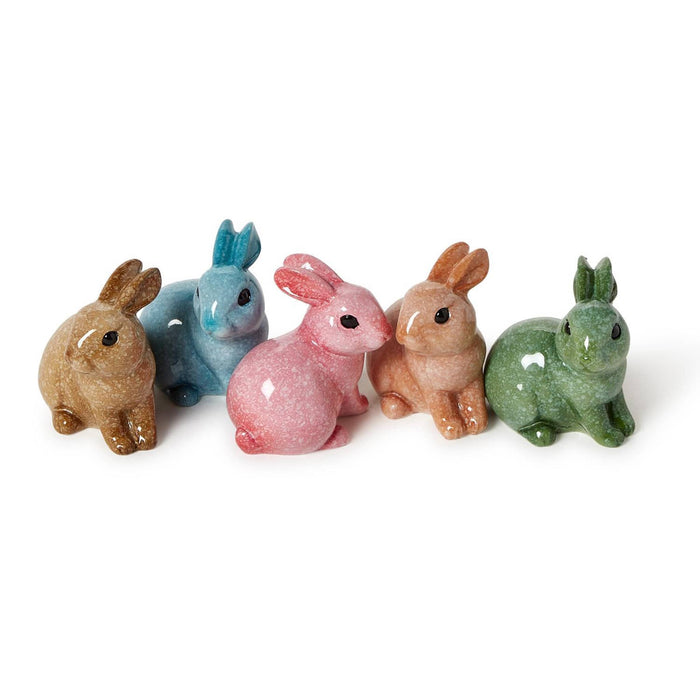 Five colorful rabbit resin figurines on a white background.