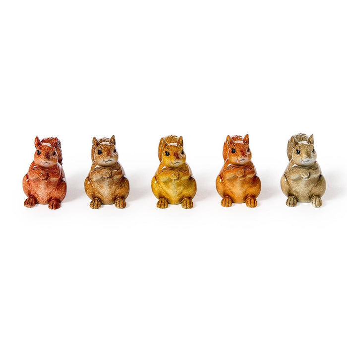 Five small squirrel figurines in different earthy colors, arranged in a row, front view, on a plain white background.