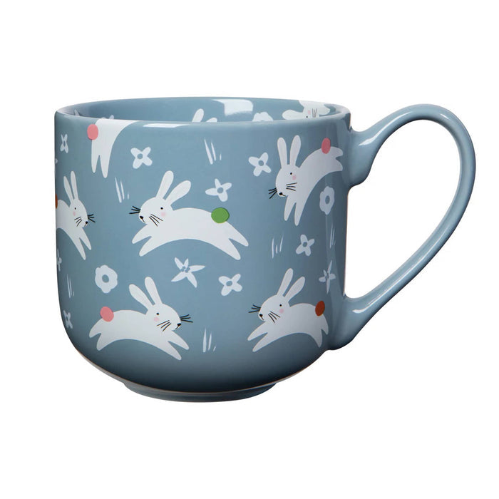 Blue mug with rabbit pattern on a white background.