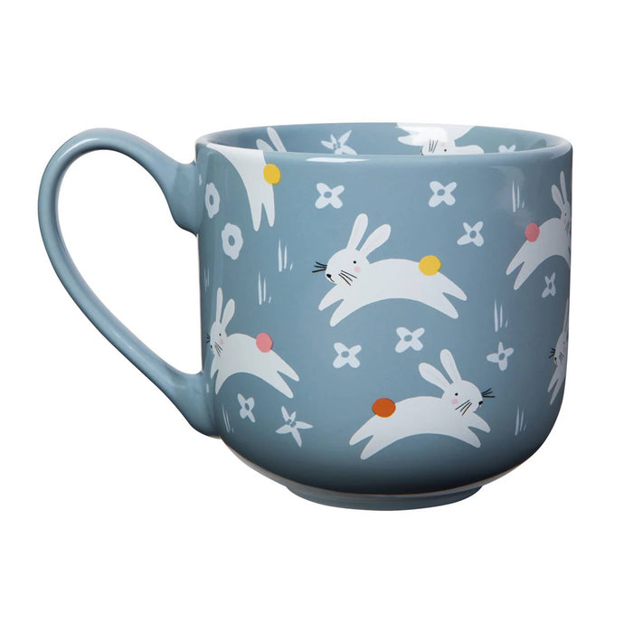 Blue mug with rabbit pattern on a white background.