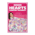 Hearts comfort blanket packaging with a pink background and a person holding the blanket.