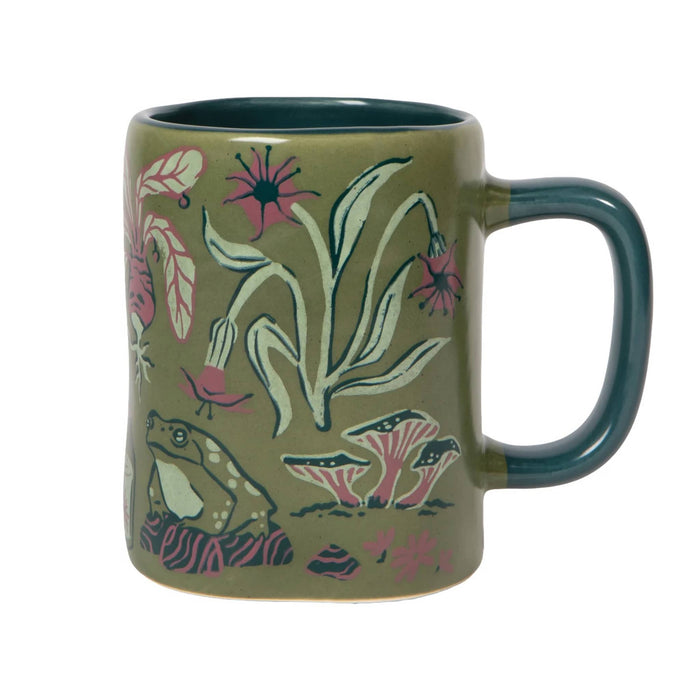 An olive green ceramic mug featuring a hand-painted style illustration of a green frog, pink flowers, and white leaves, with a dark teal handle and interior.
