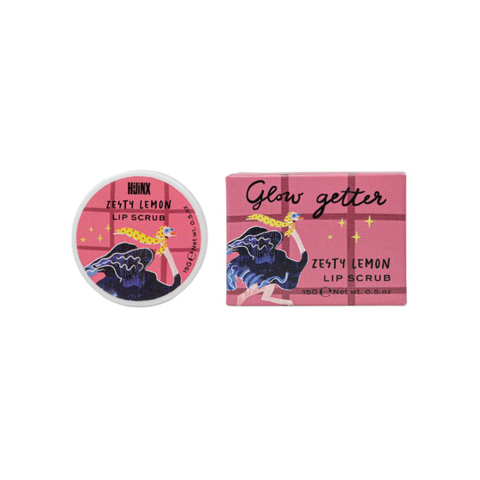 A round tin of Hijinx Zesty Lemon Lip Scrub next to its pink rectangular box packaging, both featuring an illustration of an ostrich with a yellow scarf on its head against a pink grid background.