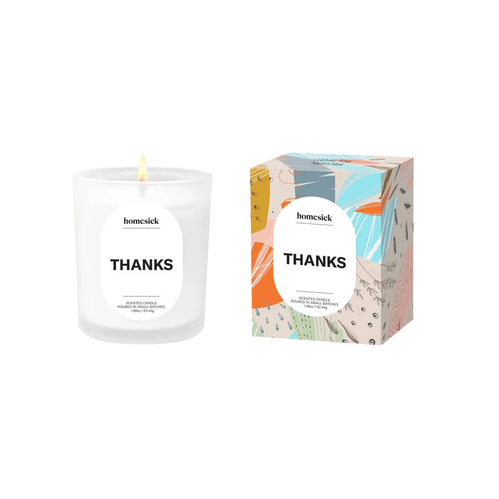 Homesick 'Thanks' mini candle and colorful box packaging on a beige background.