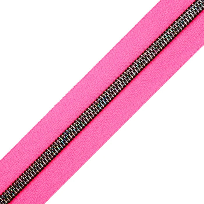 A very bright and fluorescent hot pink zipper tape with midnight rainbow coil teeth.
