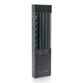 A tall rectangular box of ILLUME assorted taper candles in black, shown on a clean white background. The box has a clear window revealing the tapers inside.