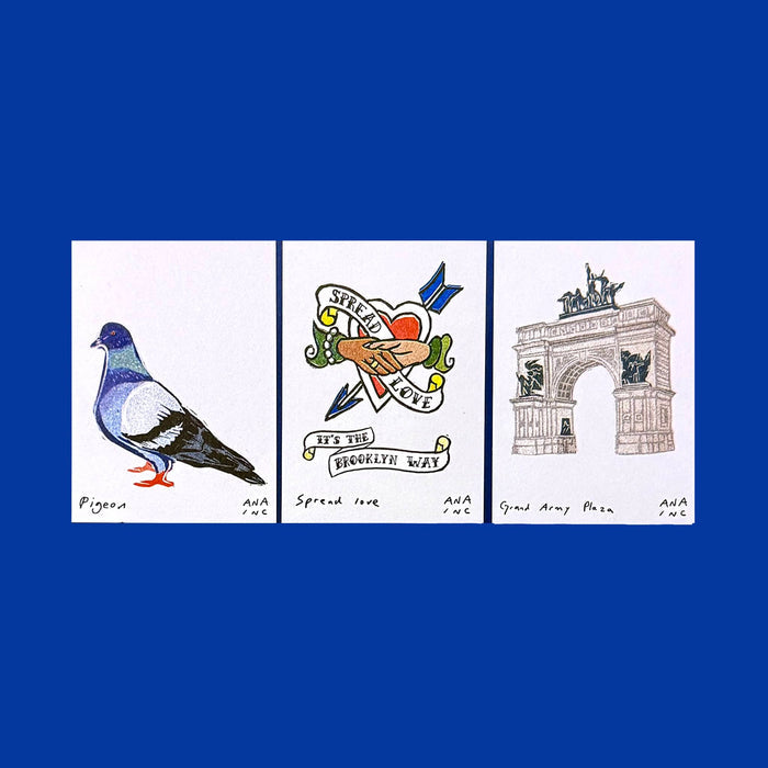 Annie's exclusive mini prints of a pigeon, a tattoo heart with handshake, and the Grand Army Plaza arch on a blue background.
