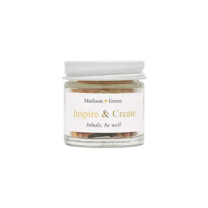 Inspire and Create aromatherapy inhaler in a glass jar, front view, on a white background.