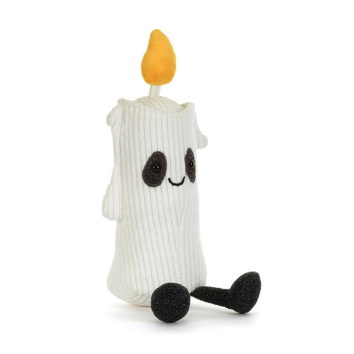A white corduroy ghost candle plush toy with a yellow-orange flame on top, black embroidered eyes and mouth, and black feet, front angle view, shown on a plain white background.