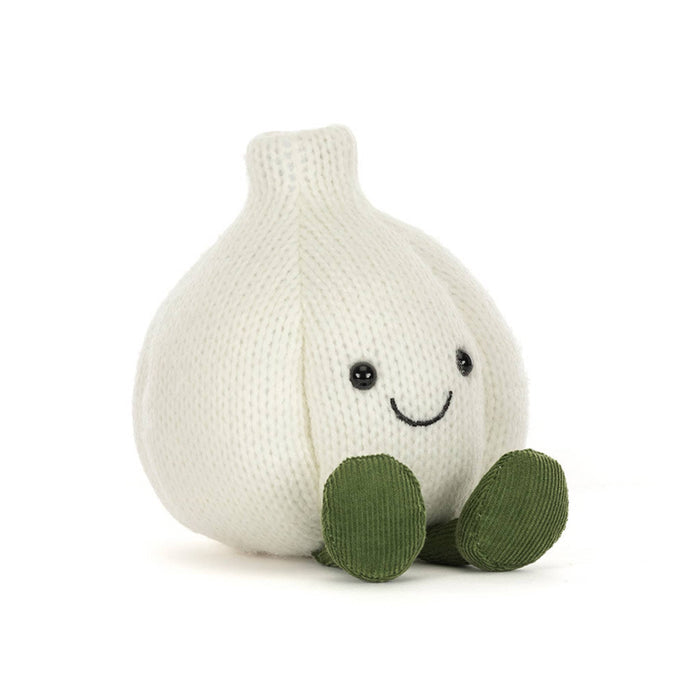 A knitted garlic plush toy in off-white with olive green corduroy feet and a simple embroidered smiley face, front angle view, shown on a clean white background.