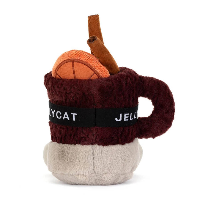 A plush toy shaped like a mulled spiced drink in a mug with a smiling face, wearing orange ski goggles and brown boots, back view, on a solid white background.