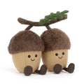 Two plush acorns with faces connected with a velvet branch, front angle view, on a white background.