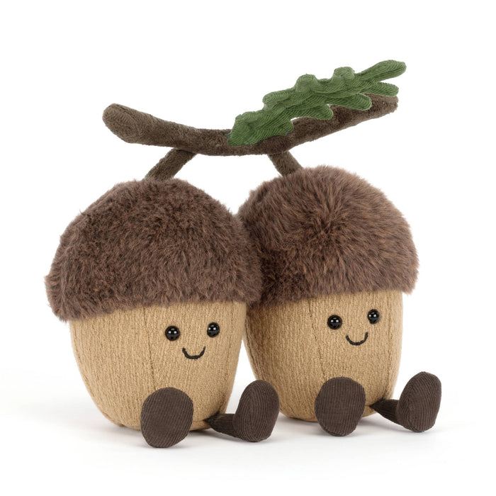 Two plush acorns with faces connected with a velvet branch, front angle view, on a white background.