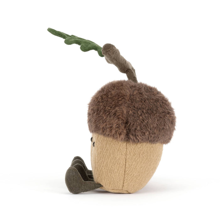 Two plush acorns with faces connected with a velvet branch, side view, on a white background.
