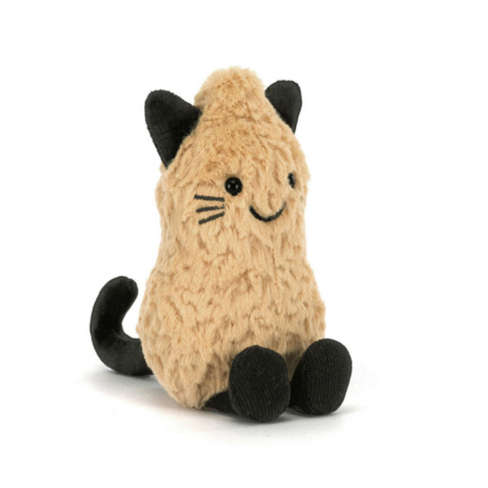A plush peanut toy in a warm beige/tan color with black cat ears, paws, whiskers, and tail, front angle view, sitting against a plain white background.