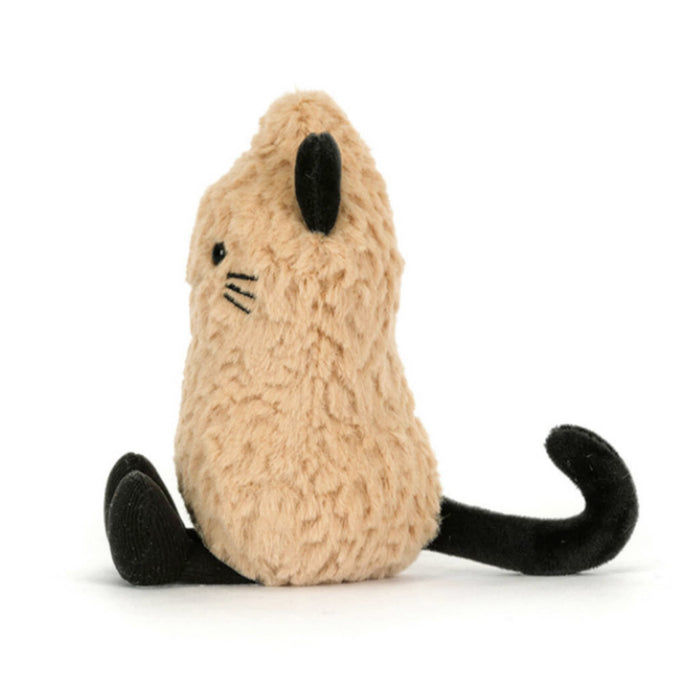 A plush peanut toy in a warm beige/tan color with black cat ears, paws, whiskers, and tail, side view, sitting against a plain white background.