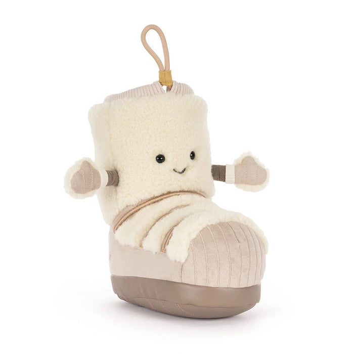 A snow boot-shaped plush toy with a cream sherpa upper, beige corduroy-like lower section, and a tan hanging loop at the top, front angle view, shown on a plain white background.