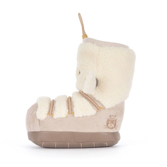 A snow boot-shaped plush toy with a cream sherpa upper, beige corduroy-like lower section, and a tan hanging loop at the top, side view, shown on a plain white background.