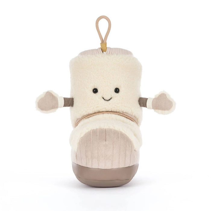 A snow boot-shaped plush toy with a cream sherpa upper, beige corduroy-like lower section, and a tan hanging loop at the top, front view, shown on a plain white background.