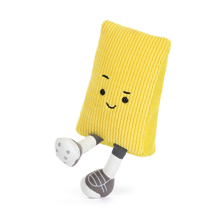 Soccer yellow card plush toy with a raised eyebrow and smile, kicking, on a white background.