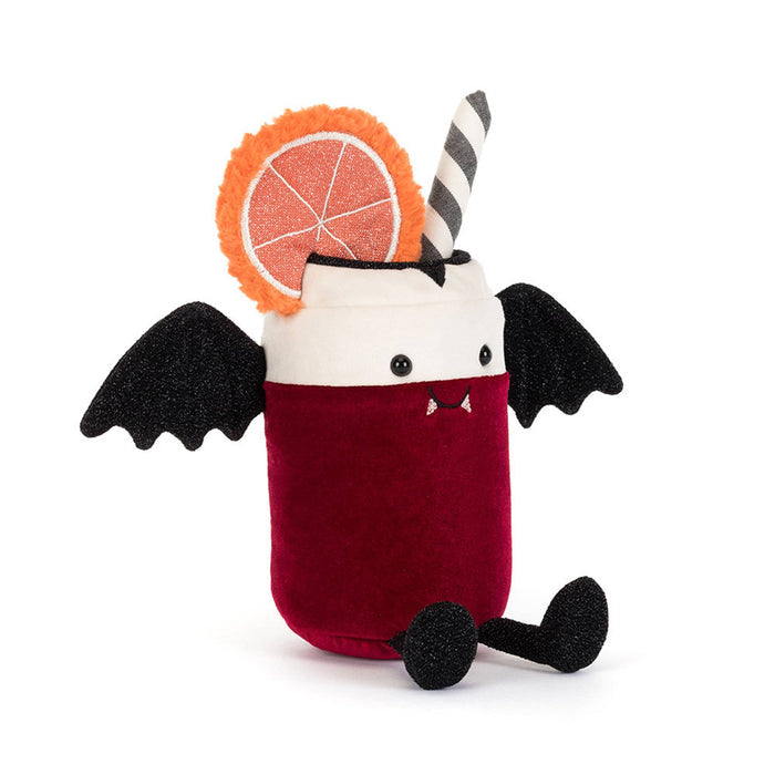 A plush toy shaped like a vampire cocktail in a can-shaped glass, with a deep red body, white rim, black wings, black feet, a striped straw, and an orange slice decoration, front angle view on a white background.