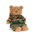 Jellycat Bartholomew Bear plush with a knit sweater in fall colors and a sleeping bag backpack, front angle view, on a white background.