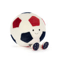 Plush toy soccer ball in red, white, and blue with smiling face, front angle view, sitting on a white background.
