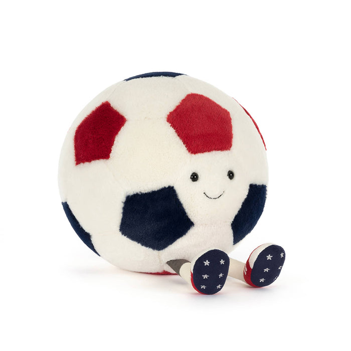 Plush toy soccer ball in red, white, and blue with smiling face, front angle view, sitting on a white background.