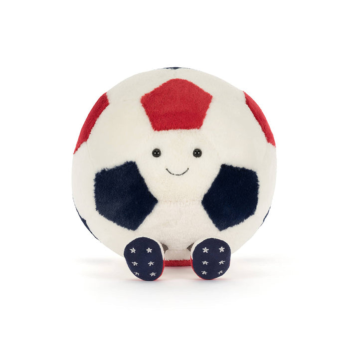 Plush toy soccer ball in red, white, and blue with smiling face, front view, sitting on a white background.