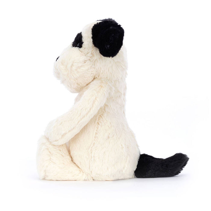 Jellycat Medium Bashful Rufferty black and cream puppy plush toy, side view on a white background.