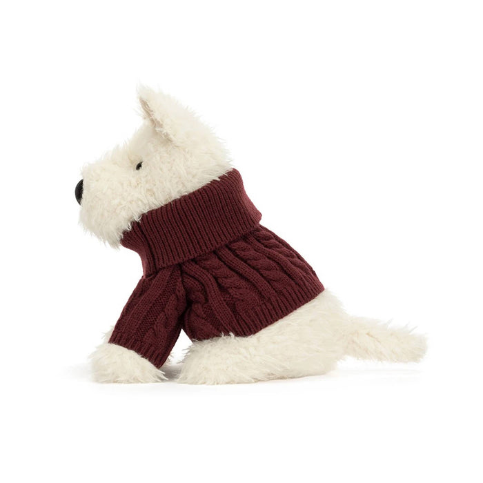 A plush white dog wearing a burgundy cable-knit sweater, side view on a plain white background.