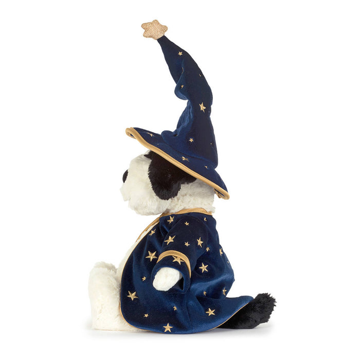 A plush dog toy dressed as a wizard, featuring a navy blue velvet robe and pointed hat with gold star patterns and trim, side view, against a plain white background.