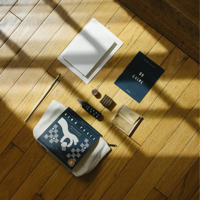 JOYN Blok Parti Check and Dot Pouch Block Printing Set contents including a cream canvas pouch, guide book, wood blocks, and ink tray.