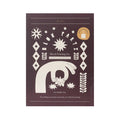 Front of JOYN Blok Parti Fern Ruffle Tote Block Printing Set, featuring a dark mahogany background with cream-colored block printing illustrations of hands, stars, and geometric patterns, on a plain white background.